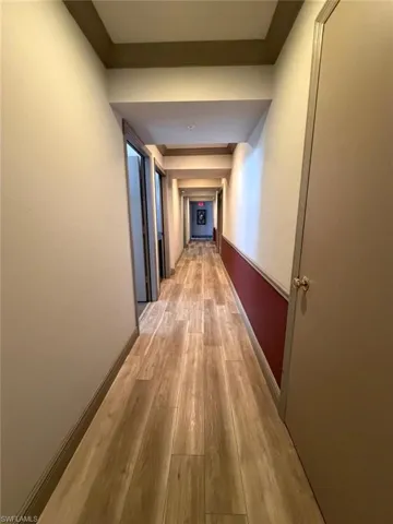 Hall featuring light wood-style floors and baseboards