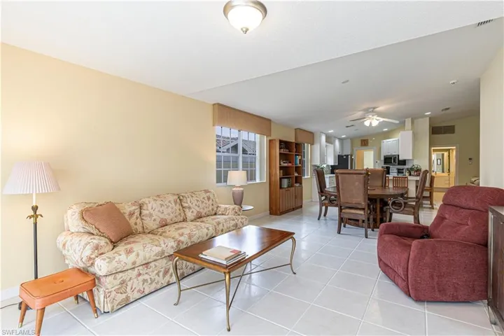 Living room featuring ceiling fan and light tile patterned flooring