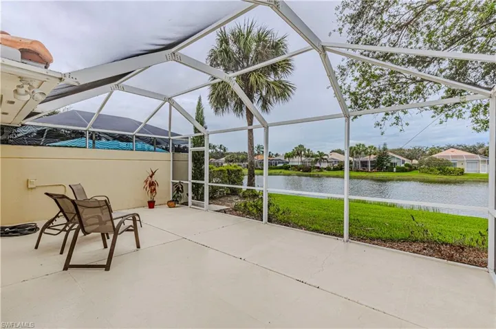 View of patio / terrace with a lanai and a water view