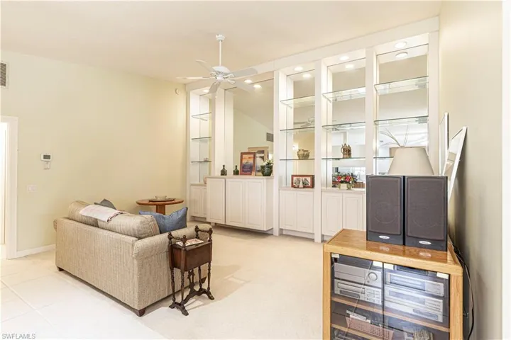 Living room featuring ceiling fan and light tile patterned floors