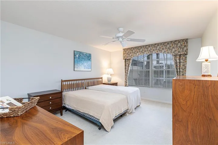 Carpeted bedroom with ceiling fan