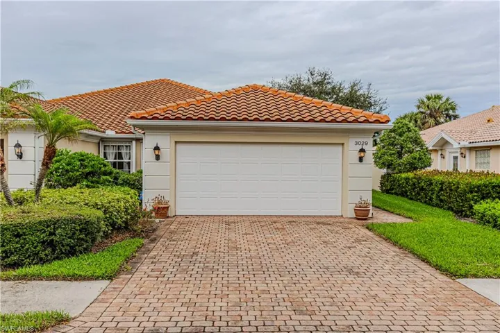 Mediterranean / spanish-style home with a garage