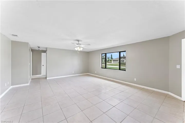 Unfurnished room featuring ceiling fan and light tile patterned floors