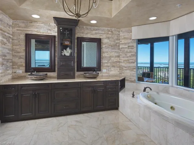 Bathroom featuring a whirlpool tub and double vanity