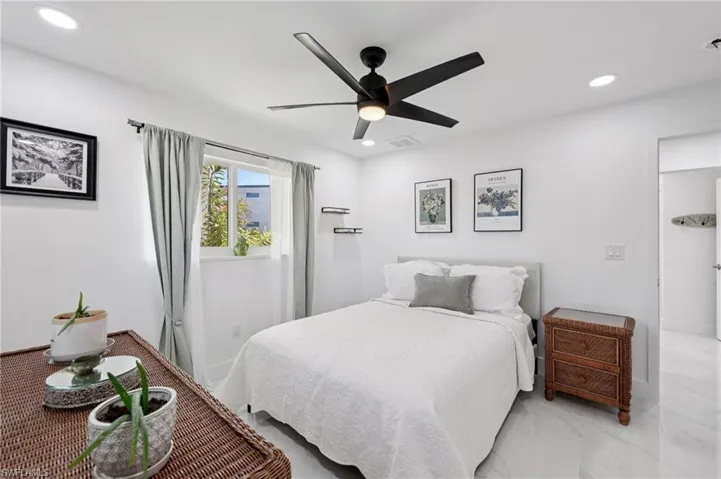 Bedroom with recessed lighting, ceiling fan, and marble finish floors