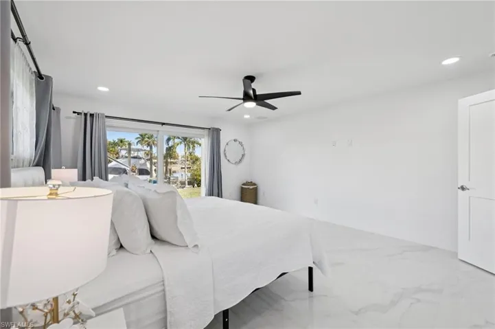 Bedroom featuring marble finish floors, ceiling fan, and recessed lighting