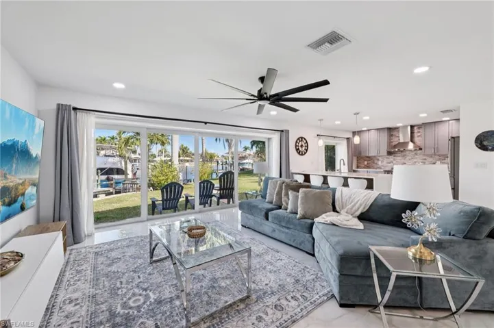 Living room featuring recessed lighting and a ceiling fan