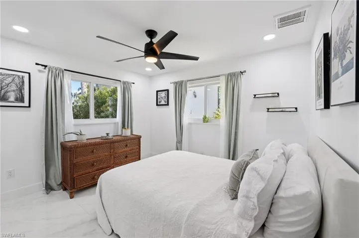 Bedroom featuring marble look tiles, a ceiling fan, and recessed lighting