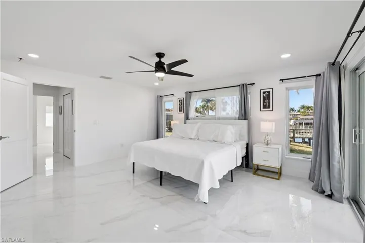 Bedroom with recessed lighting, a ceiling fan, and light marble finish floors
