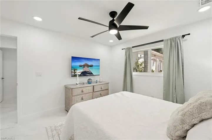 Bedroom with recessed lighting, ceiling fan, and marble finish floors