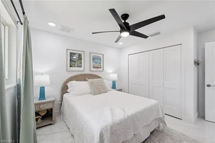 Bedroom featuring marble finish flooring, ceiling fan, a closet, and recessed lighting