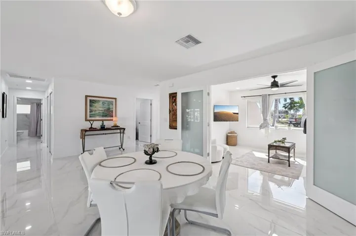 Dining room with light marble finish flooring and a ceiling fan