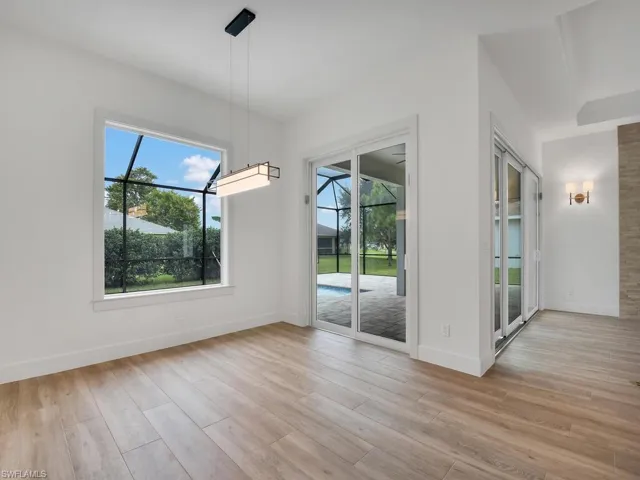 Unfurnished dining area featuring baseboards and light wood-type flooring