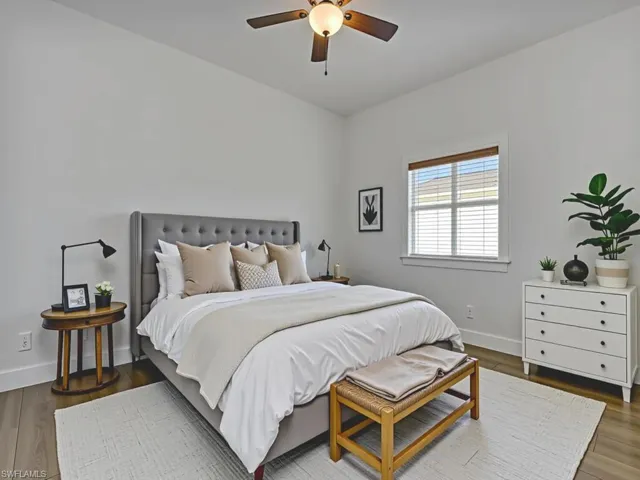 Bedroom featuring dark wood-type flooring and a ceiling fan