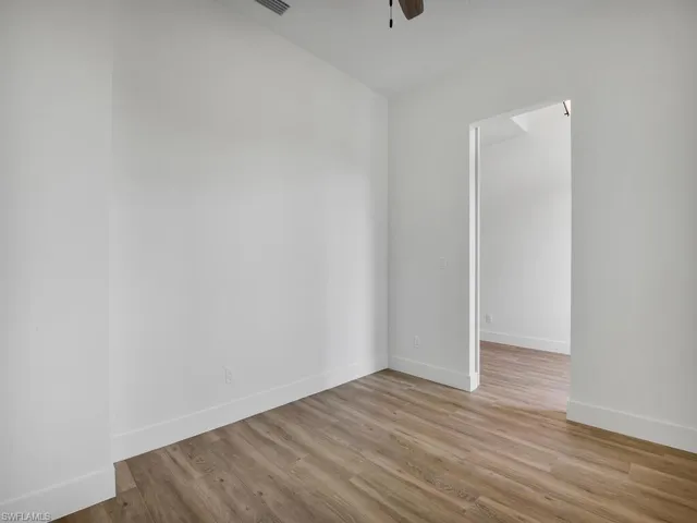 Unfurnished room featuring light wood-style floors and ceiling fan