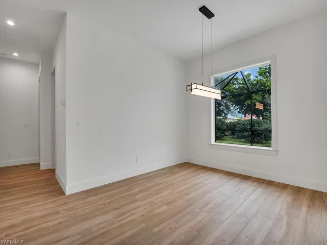 Unfurnished dining area with light wood-style flooring and recessed lighting
