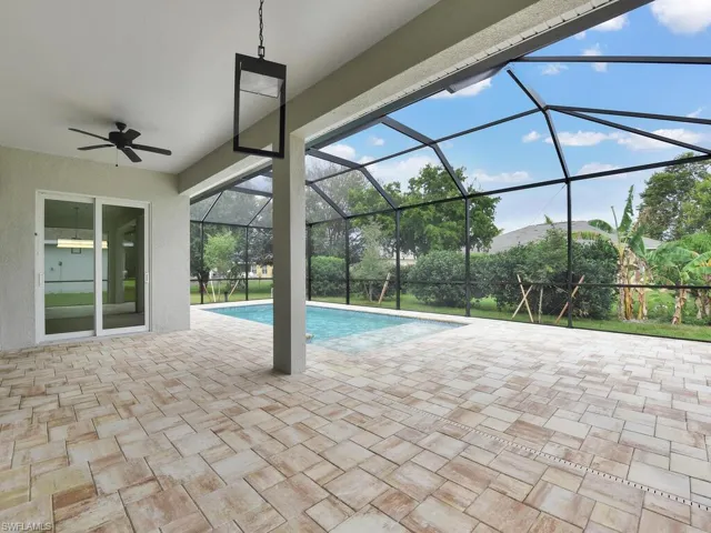 Outdoor pool with a patio, a sunroom, a lanai, and ceiling fan