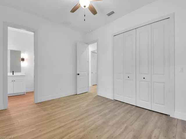 Unfurnished bedroom featuring light wood finished floors, a ceiling fan, and a closet
