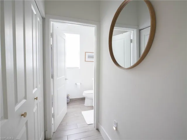 Bathroom featuring hardwood / wood-style flooring and toilet