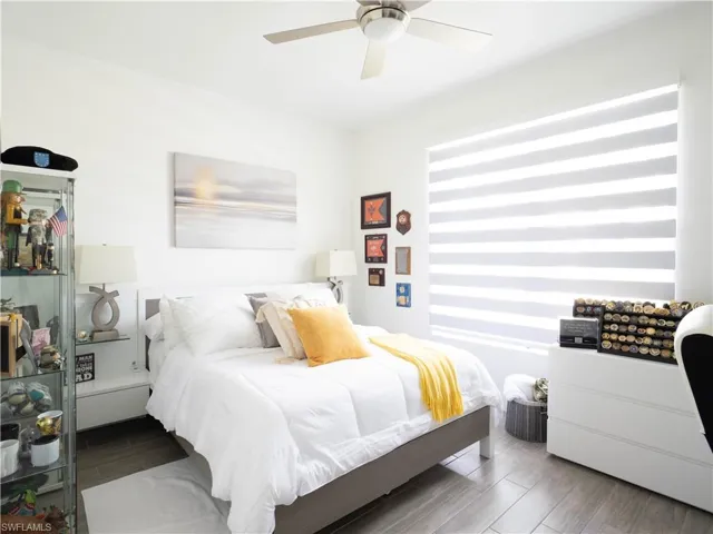 Bedroom with hardwood / wood-style floors and ceiling fan