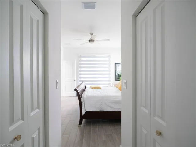 Bedroom with ceiling fan and hardwood / wood-style flooring