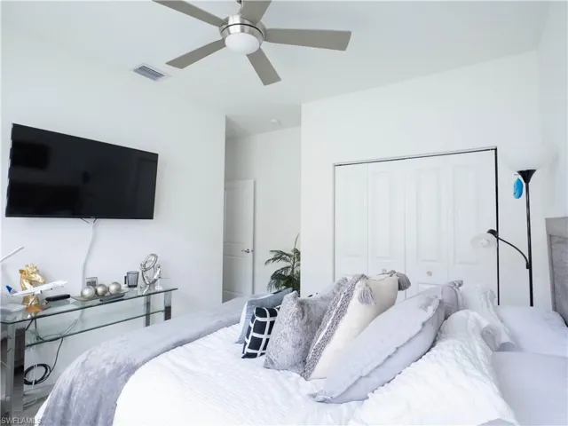 Bedroom with ceiling fan and a closet