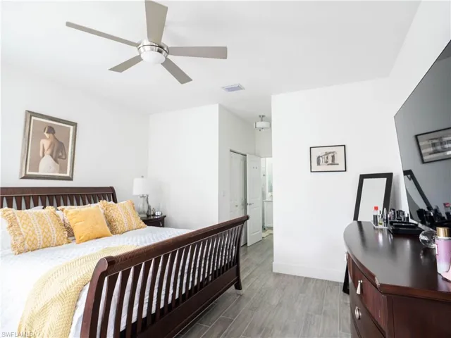Bedroom with a closet, ceiling fan, and hardwood / wood-style floors
