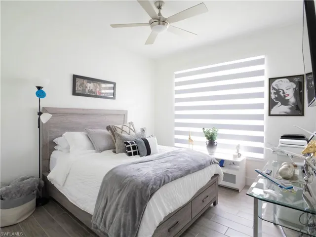 Bedroom featuring light hardwood / wood-style floors and ceiling fan