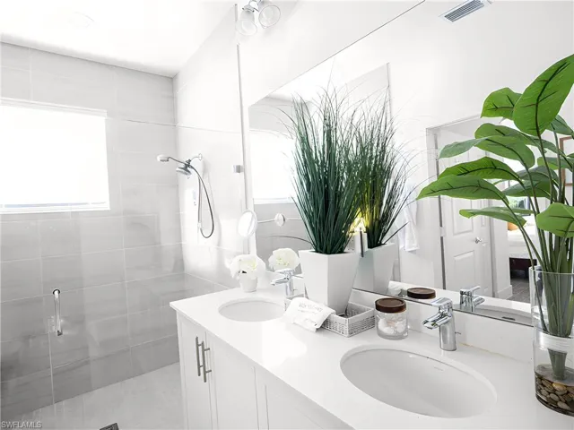Bathroom featuring vanity and a shower with shower door