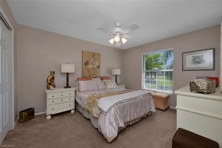 Bedroom with a closet, carpet floors, baseboards, and ceiling fan