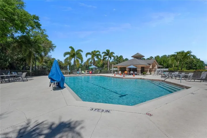 Pool with a patio and fence
