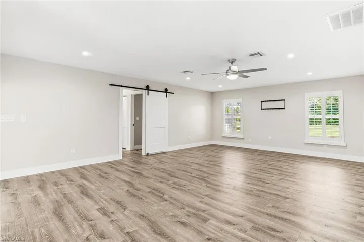 Spacious Family Room ~ Hall Leads to Guest Bedrooms, Bathroom, Laundry Room