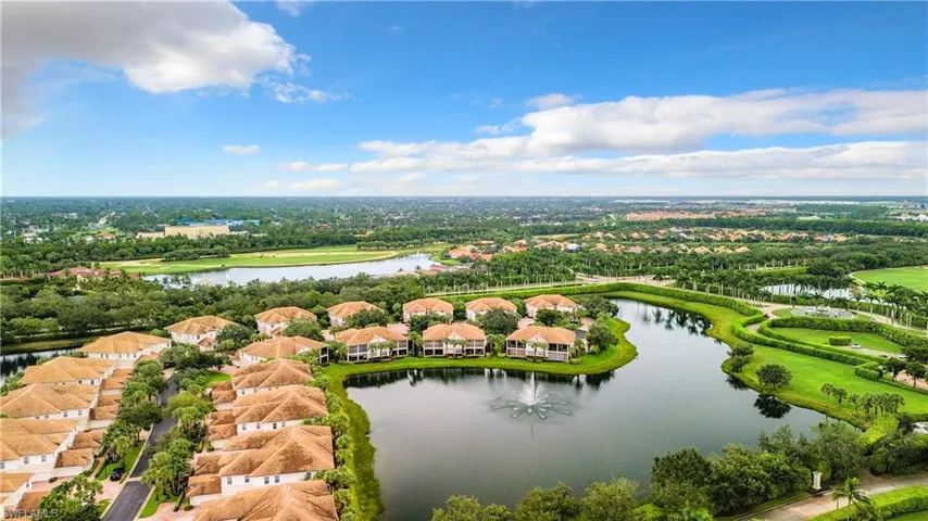 Aerial view featuring a water view and water feature.