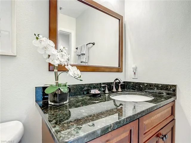Bathroom featuring cherry cabinets and granite countertop