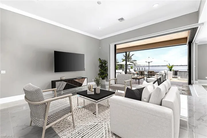 Living room with crown molding and a wealth of natural light