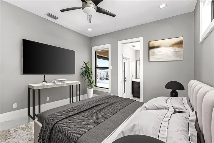 Bedroom with ceiling fan and ensuite bath