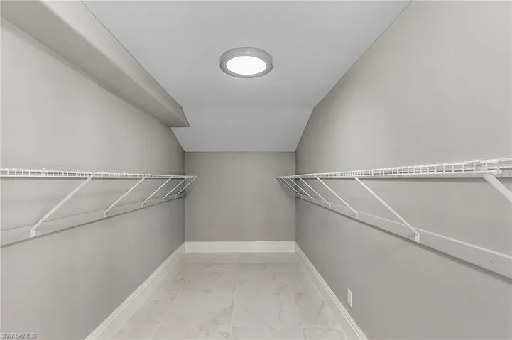 Walk in closet with lofted ceiling