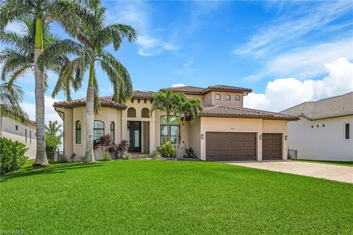 Mediterranean / spanish-style home featuring a garage and a front yard