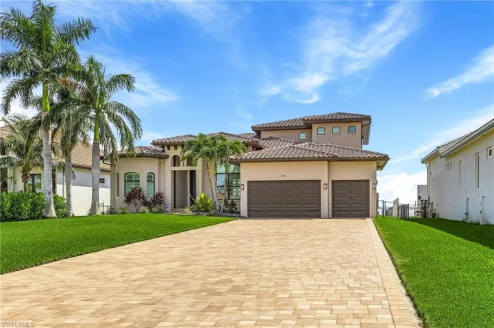 Mediterranean / spanish-style home featuring a garage and a front lawn