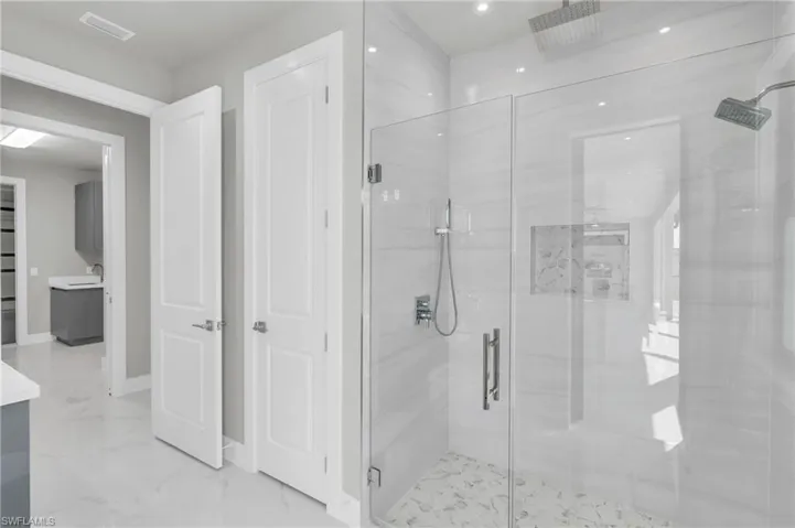 Bathroom featuring vanity and an enclosed shower
