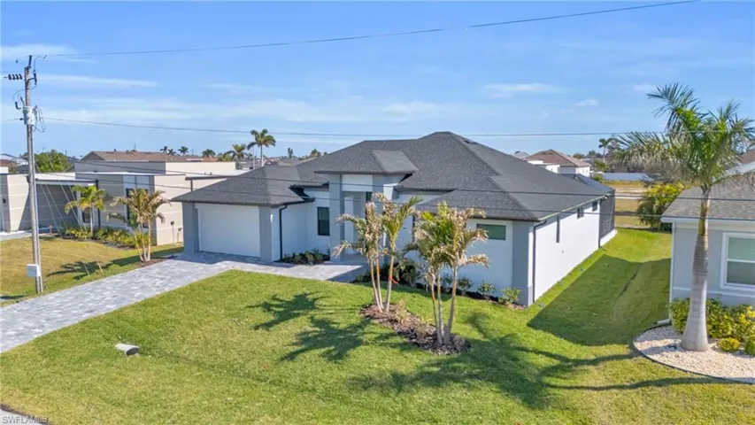 View of front of property with a garage and a front yard