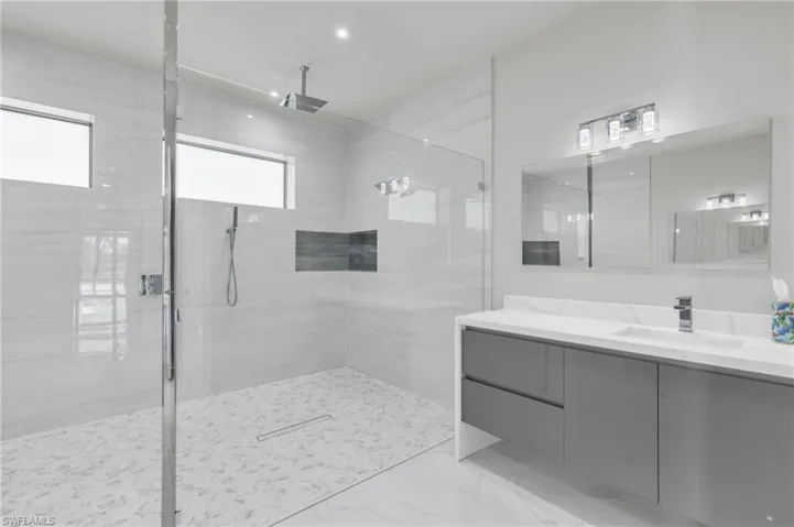 Bathroom featuring vanity and a tile shower