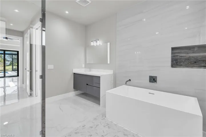 Bathroom with a washtub and vanity