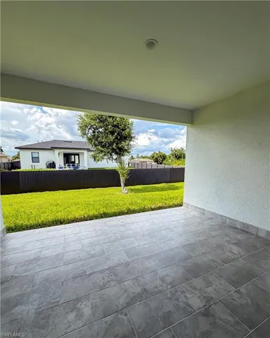 Covered patio featuring large format tile flooring and an integrated ceiling light