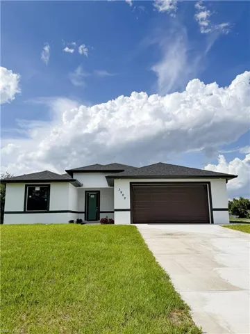 Contemporary single-story residence featuring a white stucco facade with black trim accents
