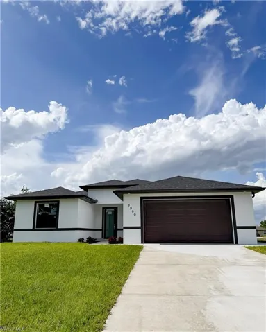 Contemporary white stucco exterior with dark trim and a dark shingle roof