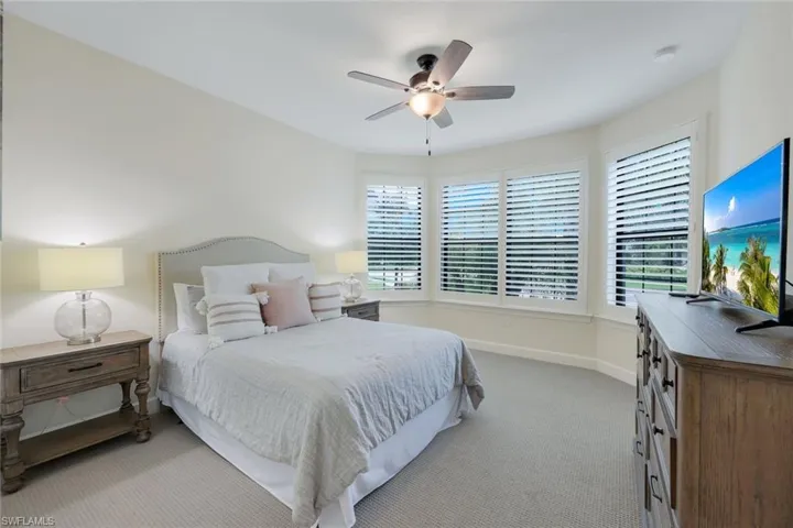 Bedroom with ceiling fan and carpet floors