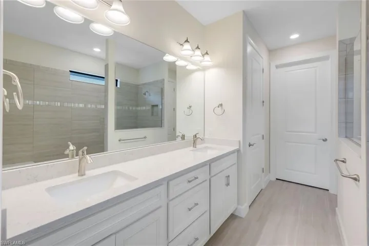 Bathroom with vanity and a tile shower