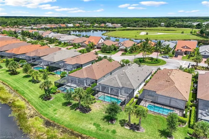 Birds eye view of property with a water view