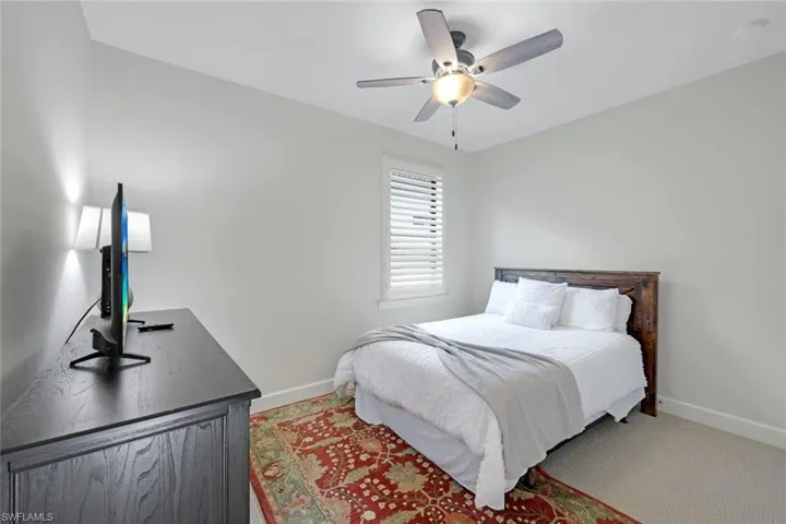 Bedroom featuring ceiling fan and carpet floors